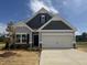 Charming single-Gathering home featuring two-car garage, stone accents, and craftsman style architecture at 202 E Victory View Ter, Smithfield, NC 27577