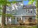 Exterior rear view of home featuring a wood deck and light blue siding at 206 Swiss Lake Dr, Cary, NC 27513