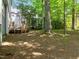 View of the backyard featuring a wood deck and mature trees at 206 Swiss Lake Dr, Cary, NC 27513