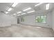 Bright basement featuring drop ceiling, recessed lights, and natural light from windows at 206 Swiss Lake Dr, Cary, NC 27513