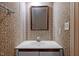 Small bathroom has patterned wallpaper, framed mirror, and sink with vanity at 206 Swiss Lake Dr, Cary, NC 27513