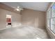 Large bedroom featuring vaulted ceiling, neutral carpet, a window, and door to the Primary bath at 206 Swiss Lake Dr, Cary, NC 27513