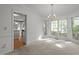 Bright dining area boasting large windows, chandelier, and kitchen access at 206 Swiss Lake Dr, Cary, NC 27513