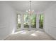 Dining area featuring a chandelier, large windows providing natural light at 206 Swiss Lake Dr, Cary, NC 27513