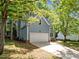 Exterior view of a two-story home with blue siding and an attached garage at 206 Swiss Lake Dr, Cary, NC 27513