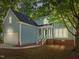 Charming home features a two-car garage and a welcoming front porch with white railings at 206 Swiss Lake Dr, Cary, NC 27513