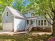 Charming home features a two-car garage and a welcoming front porch with white railings at 206 Swiss Lake Dr, Cary, NC 27513