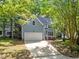 Two-story home features a two-car garage and a welcoming front porch with white railings at 206 Swiss Lake Dr, Cary, NC 27513