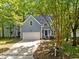 Exterior of a two-story house with blue siding, white garage door, and manicured lawn at 206 Swiss Lake Dr, Cary, NC 27513