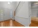 Inviting foyer with hardwood floors and a staircase with white trim; the front door is on the left at 206 Swiss Lake Dr, Cary, NC 27513