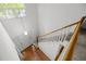 High angle shot of the bright foyer with wood floors, a staircase, and a pendant light at 206 Swiss Lake Dr, Cary, NC 27513