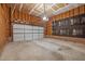 Interior view of a spacious garage with a large door and exposed ceiling at 206 Swiss Lake Dr, Cary, NC 27513