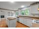 Well-lit kitchen with island, modern appliances, and breakfast nook views at 206 Swiss Lake Dr, Cary, NC 27513