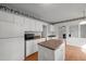 Spacious kitchen featuring an island, white cabinetry, and modern appliances at 206 Swiss Lake Dr, Cary, NC 27513