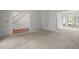 Bright living room with staircase and large windows, perfect for entertaining at 206 Swiss Lake Dr, Cary, NC 27513