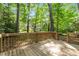 The backyard features a wood deck overlooking mature trees at 206 Swiss Lake Dr, Cary, NC 27513