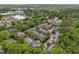 A beautiful aerial view of charming townhomes nestled among lush trees and well-manicured landscaping at 213 Old Franklin Grove Dr, Chapel Hill, NC 27514