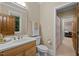 Well-lit bathroom with neutral color scheme, a sink with a wooden cabinet, and a tiled floor at 213 Old Franklin Grove Dr, Chapel Hill, NC 27514