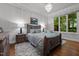 Comfortable bedroom features a large window, chandelier and a decorative painting at 213 Old Franklin Grove Dr, Chapel Hill, NC 27514