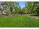 A lush green lawn surrounded by trees with stone walls, creating a peaceful communal space at 213 Old Franklin Grove Dr, Chapel Hill, NC 27514