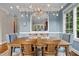Elegant dining room with a chandelier, wainscoting, and a view into the gourmet kitchen at 213 Old Franklin Grove Dr, Chapel Hill, NC 27514