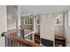 Grand foyer featuring hardwood floors, decorative railing, and ample natural light from multiple windows at 213 Old Franklin Grove Dr, Chapel Hill, NC 27514