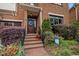 Inviting front entrance with brick steps, manicured landscaping, and a welcoming wreath on the door at 213 Old Franklin Grove Dr, Chapel Hill, NC 27514
