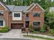 Charming brick home featuring a well-manicured lawn, two-car garage, and inviting entrance at 213 Old Franklin Grove Dr, Chapel Hill, NC 27514