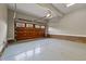 Spacious two-car garage with painted floor, exposed brick and wood paneled garage door at 213 Old Franklin Grove Dr, Chapel Hill, NC 27514