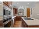 Spacious kitchen with an island cooktop, stainless steel oven and microwave, and ample countertop space at 213 Old Franklin Grove Dr, Chapel Hill, NC 27514