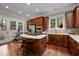 Gourmet kitchen with a center island cooktop, stainless steel appliances, and a cozy breakfast nook at 213 Old Franklin Grove Dr, Chapel Hill, NC 27514