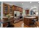 Gourmet kitchen with dark wood cabinetry, stainless steel appliances, and an island with bar seating at 213 Old Franklin Grove Dr, Chapel Hill, NC 27514