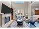 Bright living room boasts a cozy fireplace, large windows, and comfortable seating at 213 Old Franklin Grove Dr, Chapel Hill, NC 27514