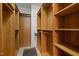 Walk-in closet with wooden shelving and hanging space at 213 Old Franklin Grove Dr, Chapel Hill, NC 27514