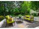 Inviting stone patio features comfortable seating and lush landscaping, perfect for relaxing or entertaining outdoors at 220 Glandon Dr, Chapel Hill, NC 27514