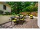 Outdoor patio with dining and seating areas, surrounded by lush greenery, offering a private retreat at 220 Glandon Dr, Chapel Hill, NC 27514
