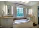 Bright bathroom with soaking tub, double vanities, and large window for natural light at 220 Glandon Dr, Chapel Hill, NC 27514