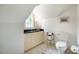 Attic bathroom with white cabinetry, toilet, and tile flooring at 220 Glandon Dr, Chapel Hill, NC 27514