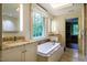 Bright bathroom with soaking tub, double vanities, and large window for natural light at 220 Glandon Dr, Chapel Hill, NC 27514