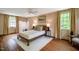 Bedroom features hardwood floors, detailed wallpaper, and plenty of sunlight at 220 Glandon Dr, Chapel Hill, NC 27514