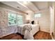 Serene bedroom with white stone walls, wooden floors, and a comfortable bed setting at 220 Glandon Dr, Chapel Hill, NC 27514