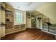 Walk-in closet features hardwood floors, large windows, custom shelving and rods at 220 Glandon Dr, Chapel Hill, NC 27514