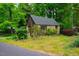 Charming stone cottage with lush greenery and a well-maintained lawn at 220 Glandon Dr, Chapel Hill, NC 27514