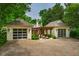 View of brick driveway with a pergola connecting two garages with modern doors at 220 Glandon Dr, Chapel Hill, NC 27514