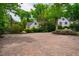 Large paver driveway is surrounded by lush greenery and meticulous landscaping at 220 Glandon Dr, Chapel Hill, NC 27514