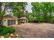 View of brick driveway and two garages connected with a pergola over the path at 220 Glandon Dr, Chapel Hill, NC 27514
