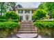 Stunning two-story home featuring stone steps leading to the main entrance and lush, mature landscaping at 220 Glandon Dr, Chapel Hill, NC 27514