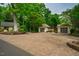 Long shot of a paved driveway leading to the property and separate garages at 220 Glandon Dr, Chapel Hill, NC 27514