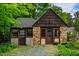 Charming stone cottage with a unique facade, mature landscaping, and welcoming front entrance at 220 Glandon Dr, Chapel Hill, NC 27514