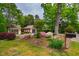 Beautiful landscaped yard featuring garage, pergola and mailbox at 220 on stone column at 220 Glandon Dr, Chapel Hill, NC 27514